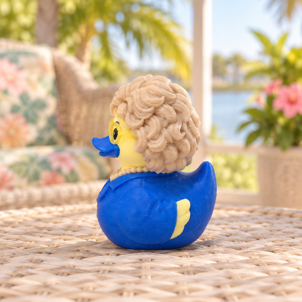Golden Girl Rose Duck collectible left side view on a sunny Florida lanai