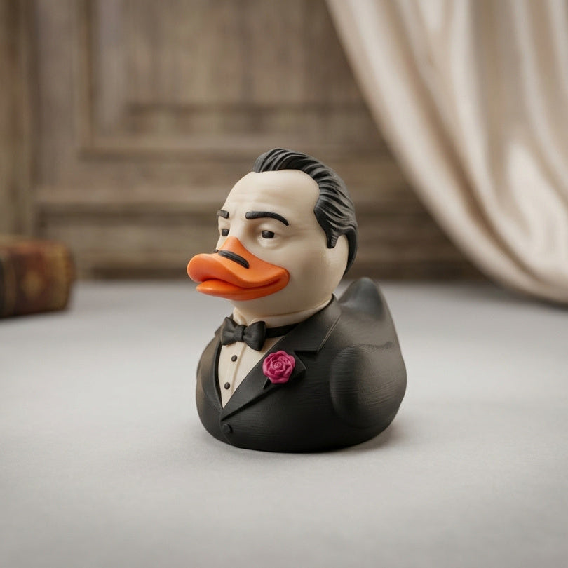 The Quackfather Duck 3D printed collectible in a tuxedo with a red rose